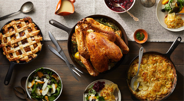 Thanksgiving spread with roast turkey, lattice apple pie, and potato gratin in Field Cast Iron Skillets